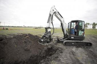 Bobcat plate compactor attachment is used with a compact excavator to compact dirt in a trench.