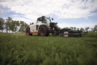 Front profile of V417 VersaHANDLER telescopic tool carrier with Bobcat mower attachment.