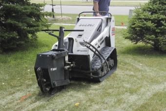 Bobcat MT55 mini track loader using a vibratory plow to install sprinkler lines in a back yard.