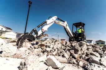  Bobcat R-Series E32 compact (mini) excavator with three-tine grapple attachment.