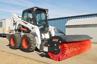 Bobcat T770 compact track loader sweeps a construction site with an angle broom attachment.
